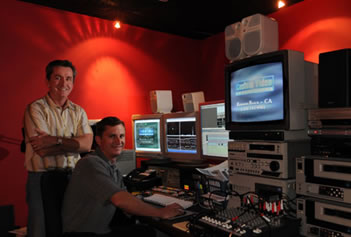 a photo of two men working in a VHS To DVD Video Encoding Service room